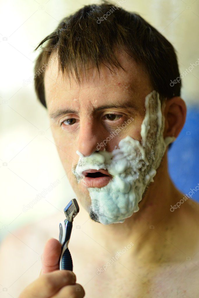 Down syndrome man shaving