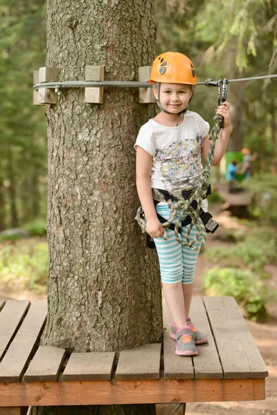Girl climbing in the trees — Stock Photo, Image