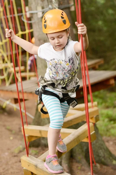 Girl climbing in the trees — Stock Photo, Image