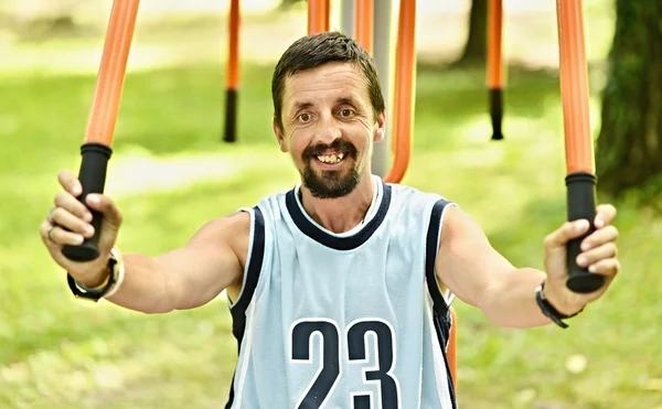 Entrenamiento de hombre en una máquina de fitness — Foto de Stock