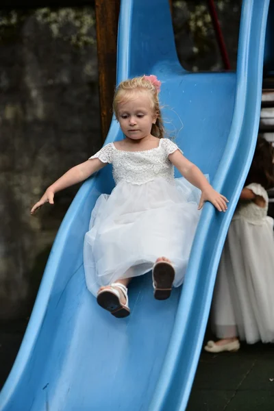 Little bridesmaid in playground — Stock Photo, Image