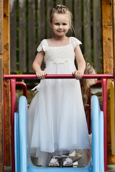 Little bridesmaid in playground — Stock Photo, Image