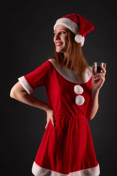 Fröhliches Mädchen Roten Weihnachtsmann Kostüm Mit Getränk Posiert Studio — Stockfoto