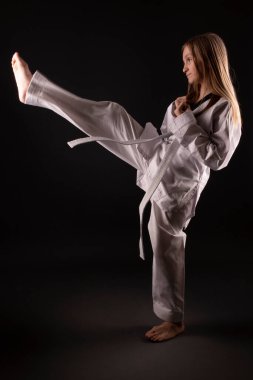 Young girl training martial art of taekwondo 