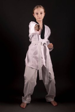 Young girl training martial art of taekwondo 