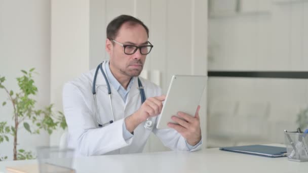 Medelålders läkare som arbetar på Tablet in Office — Stockvideo