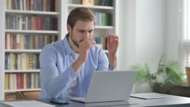 Ofiste dizüstü bilgisayar kullanırken Kayıplara Tepki Veren Adam