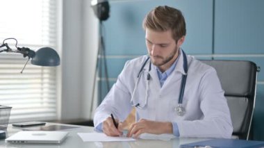 Klinikte Otururken Kağıda Yazan Doktor 