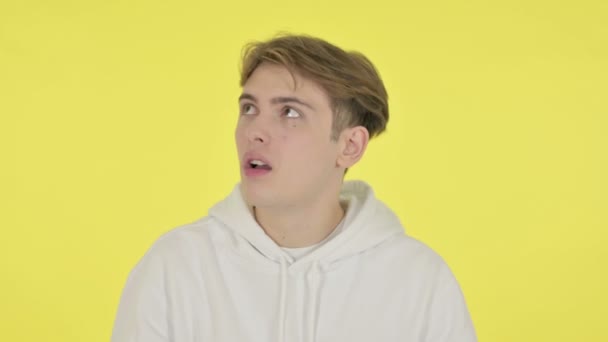 Young Man Feeling Scared, Frightened on Yellow Background — Stock Video