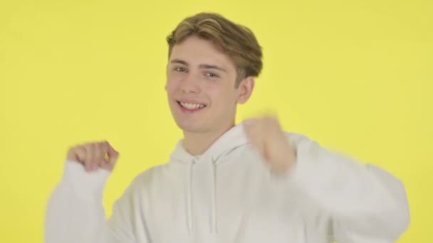 Young Man Dancing in Joy on Yellow Background — Stock Video