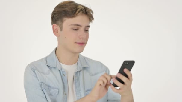 Hombre joven navegando Smartphone sobre fondo blanco — Vídeos de Stock