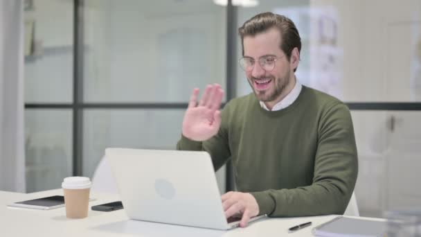 Joven Empresario Hablando en Videollamada en Ordenador Portátil en la Oficina — Vídeos de Stock