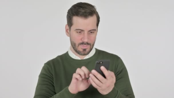 Portrait of Man Celebrating on Smartphone, White Screen — стоковое видео