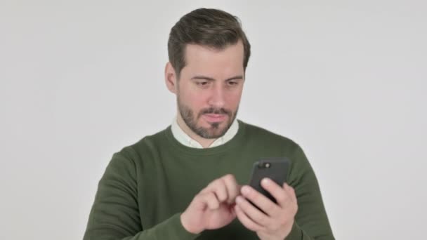 Portrait of Man Reacting to Loss on Smartphone, White Screen — Wideo stockowe