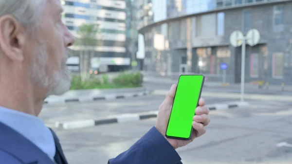 Old Man using Smartphone with Chroma Screen, Outdoor