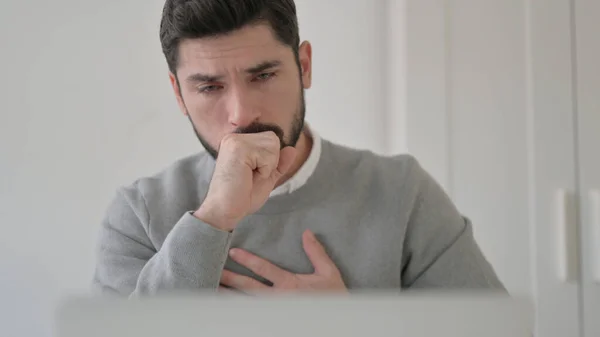 Close up of Young Man Coughing while using Laptop — Stockfoto