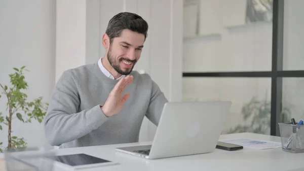 Young Man Waving Hand for Video Chat on Laptop in Office — Fotografia de Stock