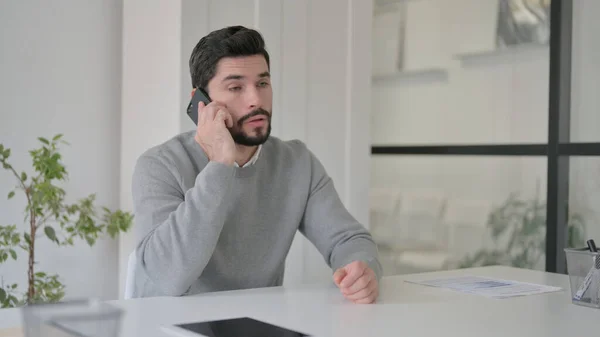 Jongeman aan het praten op Smartphone in Office — Stockfoto