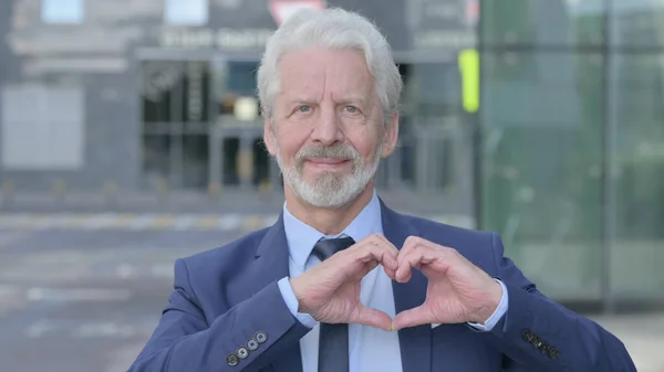 Outdoor Old Businessman Showing Heart Sign, Love