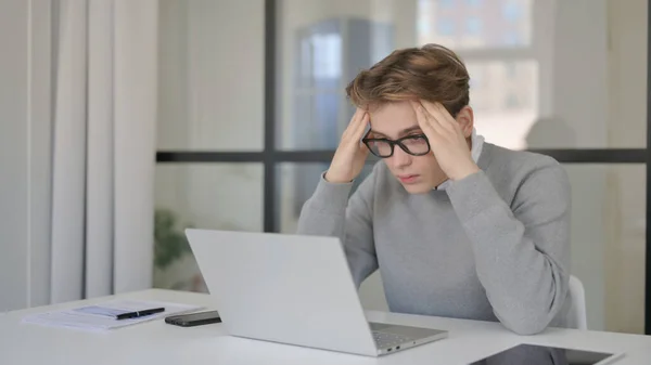 Young Man with Headache in Modern Office — Stockfoto
