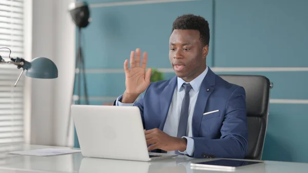 African Businessman Waving for Video Call on Laptop in Office — Stock fotografie