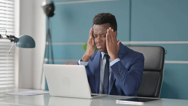 African Businessman having Headache while Working on Laptop — Stock Photo, Image