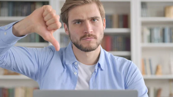 Close up of Man Showing Thumbs Down while using Laptop — Stock Photo, Image