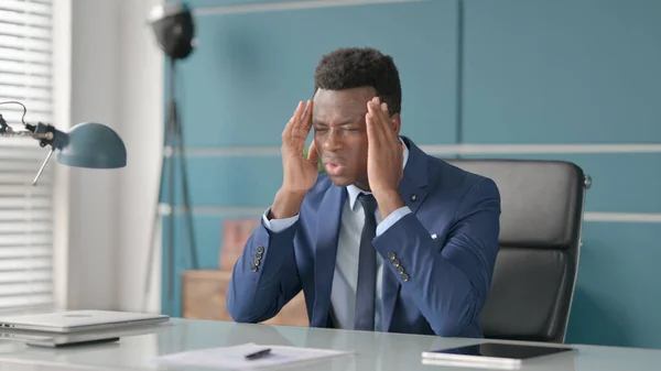 Rozrušený africký podnikatel pocit starosti při sezení v kanceláři — Stock fotografie