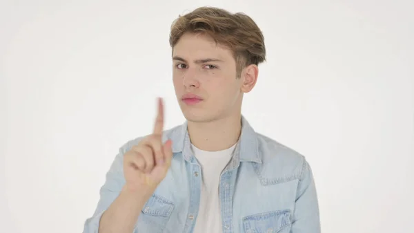 Junger Mann zeigt kein Zeichen mit dem Finger auf weißem Hintergrund — Stockfoto