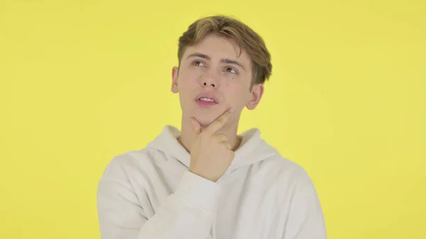 Pensive Young Man Thinking on Yellow Background — Photo