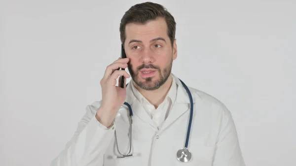 Portrait of Doctor Talking on Smartphone, White Screen — стокове фото