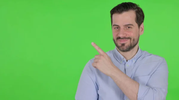 Portrait of Man Pointing Towards Product, Green Screen — Stock Fotó