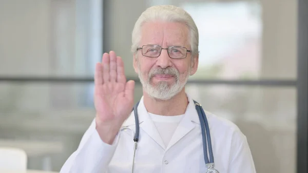 Saludando al viejo doctor hablando en videollamada en línea — Foto de Stock