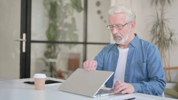 Senior oude man sluit laptop na het werk — Stockfoto