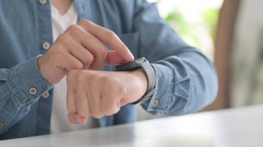 Hands of Man using Smartwatch