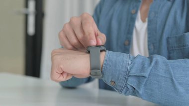 Hands of Man using Smartwatch