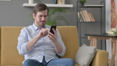 Genç adam evde akıllı telefondan kayboluyor. 