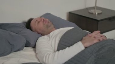 Relaxed Middle Aged Man Sleeping in Bed Peacefully 
