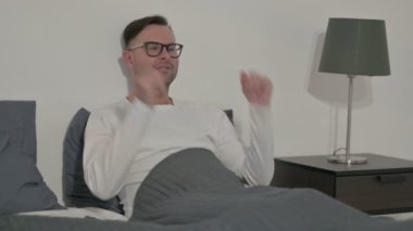 Upset Middle Aged Man Feeling Worried While Sitting in Bed