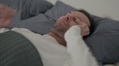 Close up Middle Aged Man Talking on Smartphone while Laying in Bed