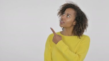 African Woman Pointing Towards Product on White Background 