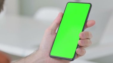 Close Up of Creative Young Man Using Smartphone with Green Screen 