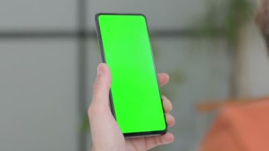 Close Up of Creative Young Man Using Smartphone with Green Screen 