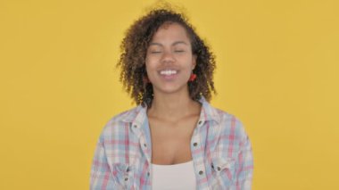 African Woman Shaking Head as Yes Sign on Yellow Background 