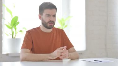 Upset Creative Young Man Worried While Sitting in Office 