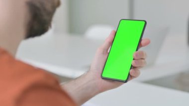 Creative Young Man Using Smartphone with Green Screen 
