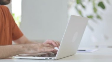 Close Up of Creative Young Man Typing on Laptop Keyboard