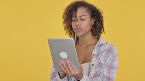 African Woman Celebrating Success Tablet Yellow Background — Vídeo de stock