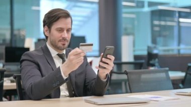 Young Businessman Reacting to Online Payment Failure on Smartphone