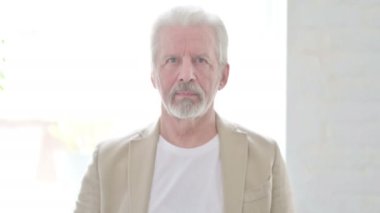 Portrait of Senior Old Man Pointing at the Camera 